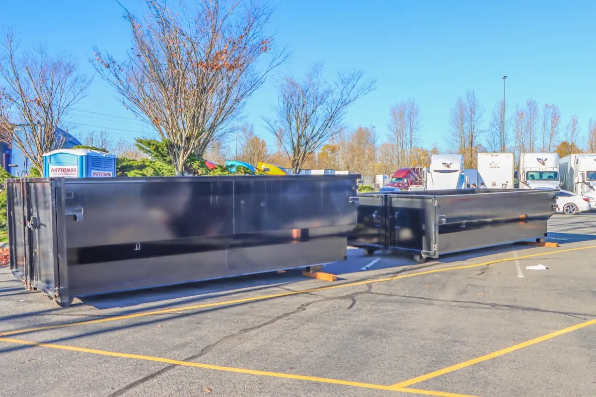 Professional dumpster rental service with roll-off container on residential driveway in Ocean Springs